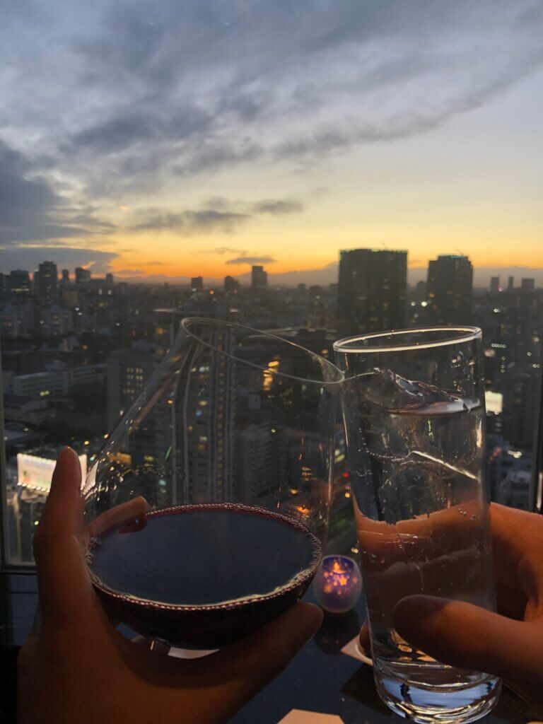 Rooftop view with wine glasses.